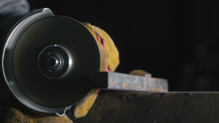 Forge workshop. Smithy manual production. Close up details, industrial worker using angle grinder...