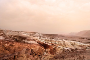 Far in the mountains of Altai. Layers of clay, lime, sand. Other planet. Mars mountains. Landscape of an unusual place. The color of iron and the atmosphere of Mars. Unusual terrain. © Sanklinarika