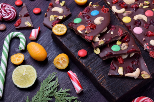 Dark chocolate bark with cashew and pistachio nuts, multicoloured sweets, dried cranberries and cherries