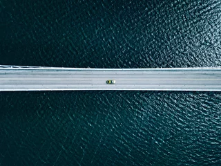 Foto op Aluminium Aerial view of bridge road with cars over lake or sea in Finland © nblxer