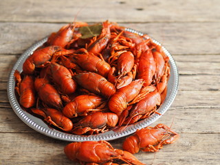 red crayfish on a plate on a wooden background