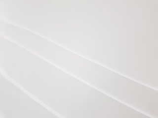 White abstract gypsum board artwork wallpaper background with curve line decoration.  Different shade reflection from light smooth surface. Copy space for text