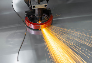 Plasma cutting of metal. Sparks fly from laser.