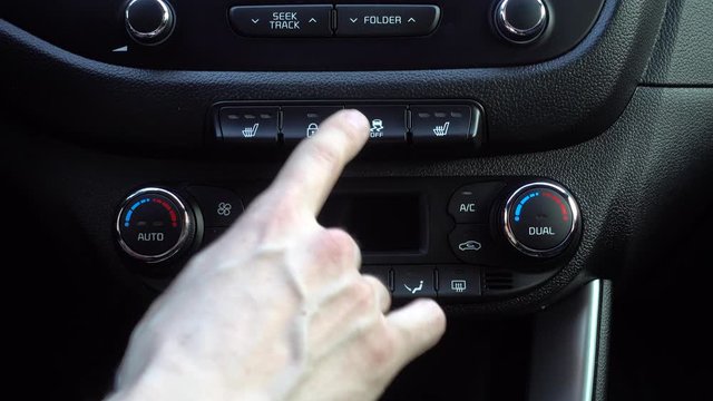 Hand finger pressing pushing button on car disable stabilization.