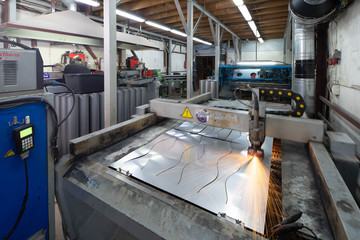 Plasma cutting of metal. View of working machine with sheet of metal. Metalworking.