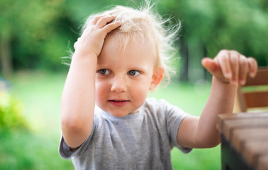 Portrait of little boy during playing in backyard