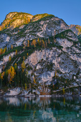 Panoramic view of Lake Braies, Italy in the background of a cliff, blue sky Autumn season
