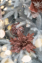 Stylish noble pink decor on a white Christmas tree.