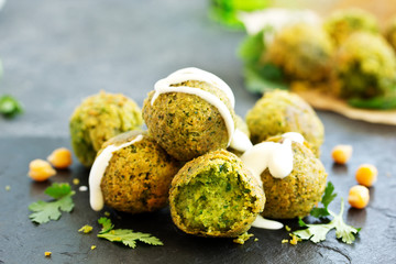 Fresh falafel balls on a dark background.