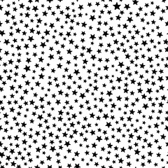 Busy all over seamless repeat pattern with tiny small ditsy black stars tossed on a white background