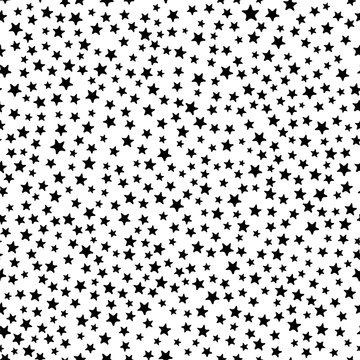 Busy all over seamless repeat pattern with tiny small ditsy black stars tossed on a white background