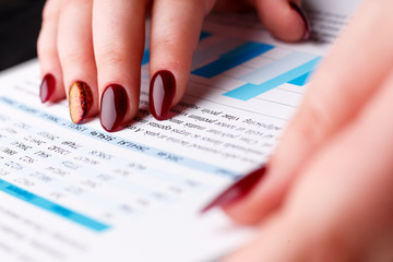 Female arm point finger in financial graph