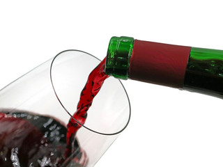 red wine pouring from green bottle into wine glass isolated on white background