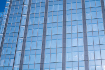 Obraz premium underside panoramic and perspective view to steel blue glass high rise building skyscrapers, business concept of successful industrial architecture