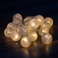 Glowing colorful Christmas lights on black background. New Year. Christmas. Decor. Garland