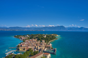 Unique view. Aerial photography, the city of Sirmione on Lake Garda north of Italy. In the background is the Alps. Resort place. Aerial view. 