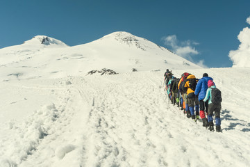 Fototapeta na wymiar Climbing Elbrus group of climbers goes in the snow to the top