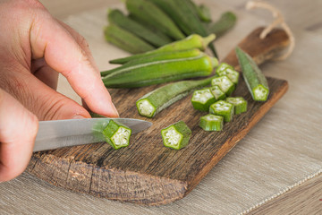 Okra. Vegeteble on a kitchen board, partly chopped