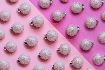 Holiday composition. Christmas balls on a pink and purple background, diagonal, hard shadows. Christmas, New Year concept. Top view, flat lay, mock up.