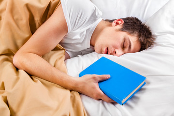 Young Man sleep with a Book