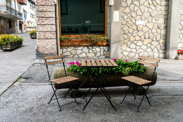 Cozy street chairs and table in heart of Cortina d'Ampezzo, Italy.