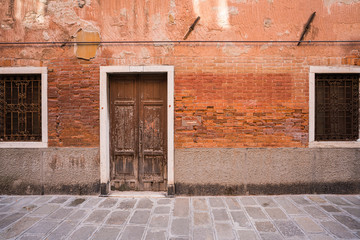 Fototapeta na wymiar Colorful orange historic building in Venice, Italy.