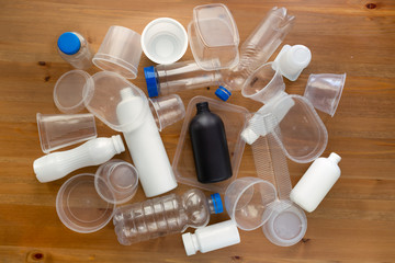 plastic packaging on wooden background. plastic packaging of food is recyclable. the concept of environmental protection and ecology, top view