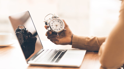 Unrecognizable afro guy checking time on his clock