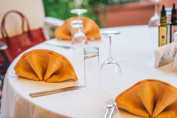 Table set up with cloth napkins. Formal dinner. Restaurant table