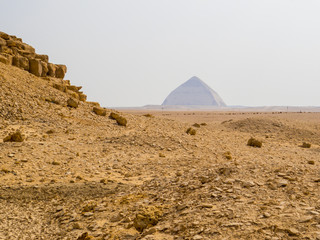 View of the base of the Red Pyramid with the Bent Pyramid in the background. Dahshur necropolis,...