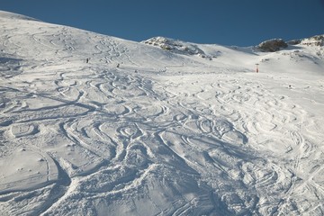 Ski and snowboard curves in the fresh snow slope