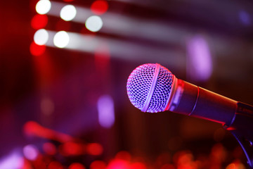 Microphone on stage with lights in background - 306735913