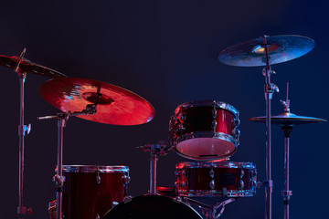 Fototapeta na wymiar professional drum set instruments in dark studio with lights . music, instruments, hobby concept