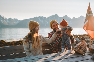 Happy family outdoor mother and father with baby together vacations parents with child healthy...