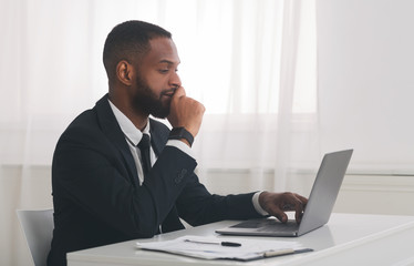 Young african american businessman studying market online