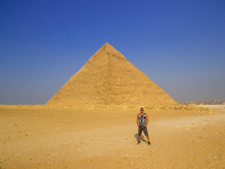 Tourist in front of the Pyramid of Khafre in the Giza Necropolis. In Cairo, Egypt