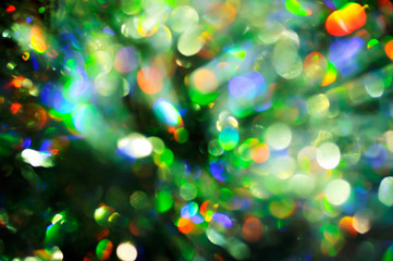 Background from multi-colored bokeh, festive texture from a blurry Christmas decor
