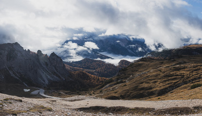 Dolomites, Italy, autumn sunset mountain landscape with clouds