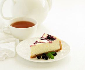 Homemade cheesecake with black currant jelly.