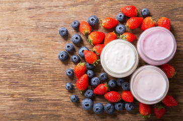 glass jars of yogurt with fresh berries, top view