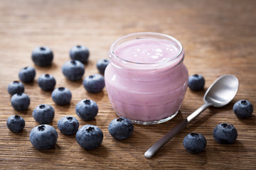 glass jar of blueberry yogurt with fresh berries