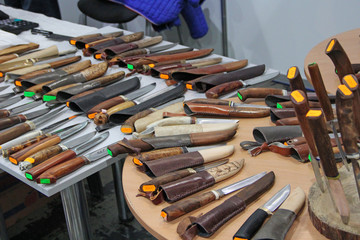 Knives for hunters at exhibition. steel arms