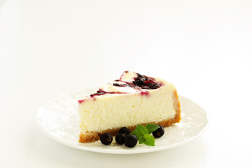 Homemade cheesecake with black currant jelly.