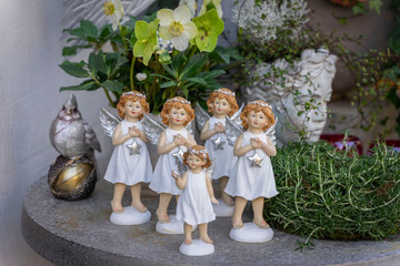 Angels with wings in the form of dolls in white dresses with shiny starlets in their hands....