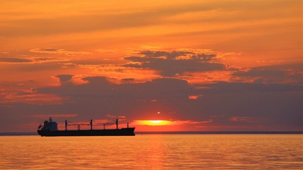 sunset on the sea with tanker ship