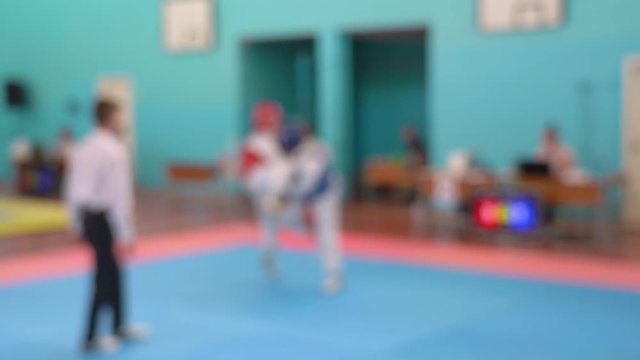 Taekwondo sport competitions between youth. Blurry video footage of young boys in sparring. Real time 4k blurry video footage.
