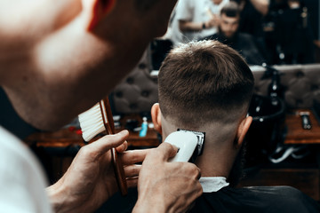 YOUNG HANDSOME BEARDED MAN IN BARBERSHOP