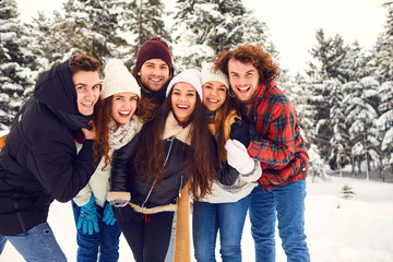 Group of friends in the park in winter