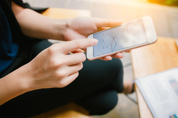 Young confident women entrepreneur dressed in luxury suit smart device during work break, intelligent male using her mobile phone while preparing for business meeting in office.