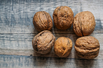 walnuts in their shell on wooden background